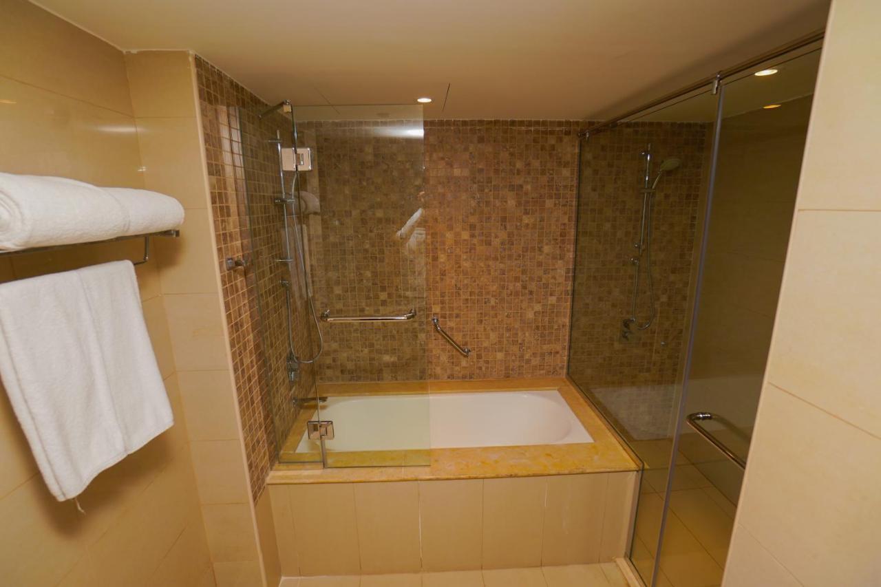 The Grand Lux Hotel Doha Exterior photo A bathtub with a shower enclosure