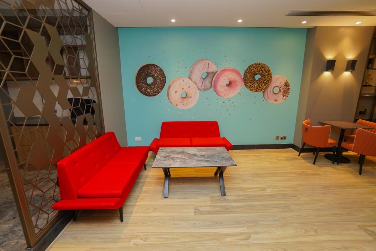 The Grand Lux Hotel Doha Exterior photo The interior of a Dunkin' Donuts in Paris, France
