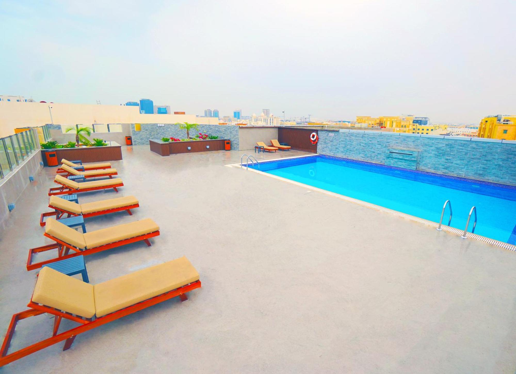 The Grand Lux Hotel Doha Exterior photo Rooftop pool at the hotel